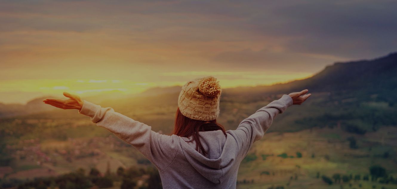 Home Page Banner of woman on mountain top